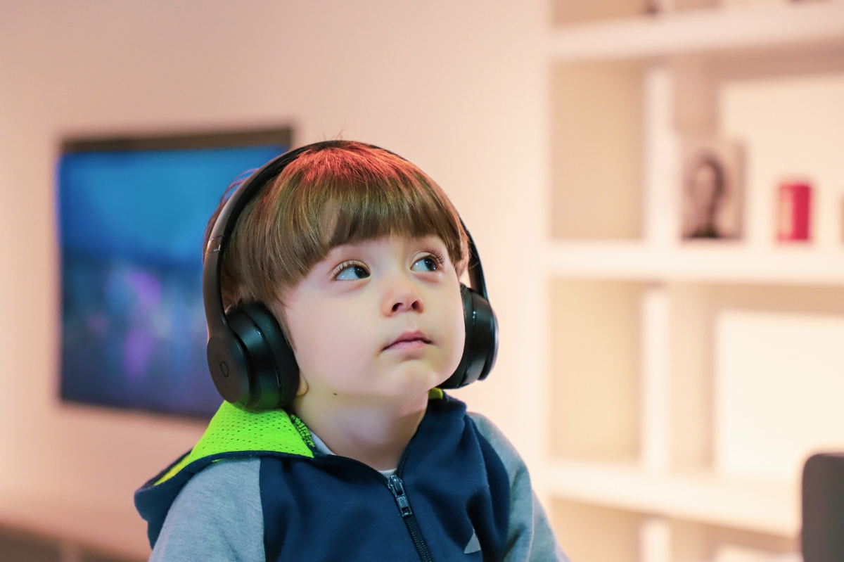 Boy using sensory head phones to ensure a controlled auditory environment