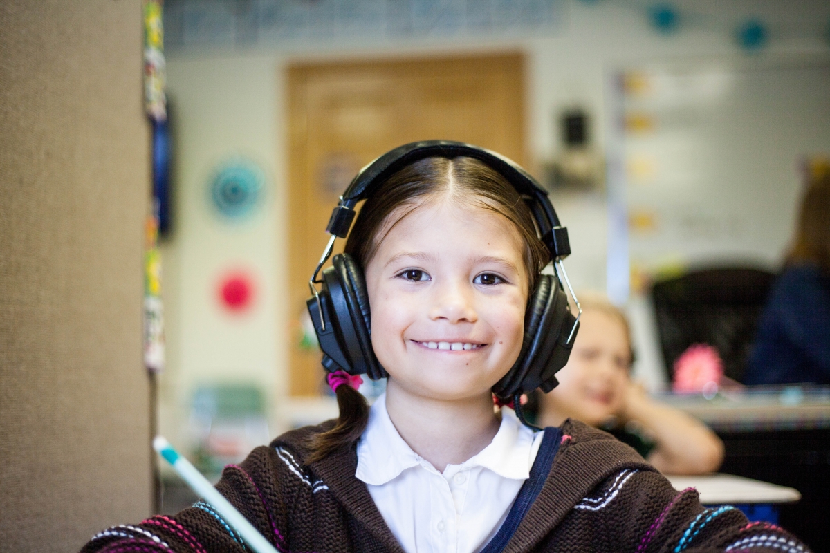 Girl using headphones to control auditory stimulations